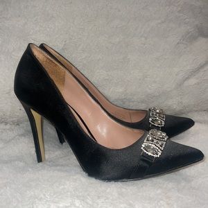 Black pointed toe heels with rhinestone design